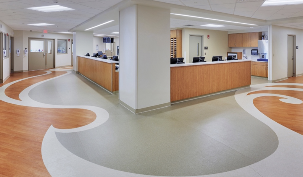 Commercial reception with curved flooring and wood paneling